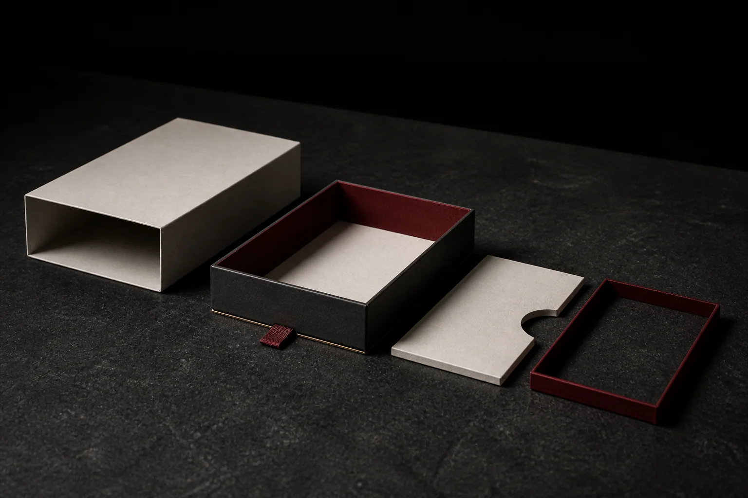 Illustrative structural study of an unbranded rigid drawer box with sleeve, tray, insert panel and pull tab separated